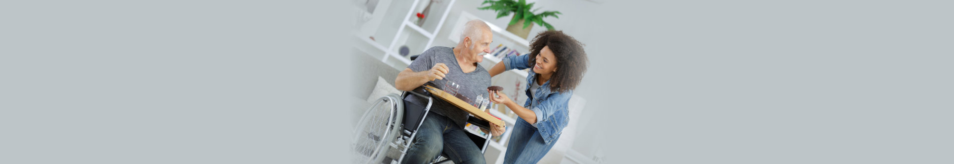an elderly man and a caregiver smiling together