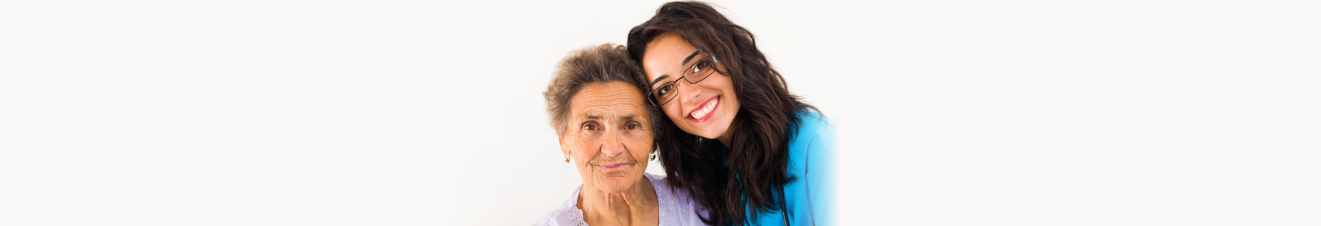 an elderly woman with her caregiver smiling