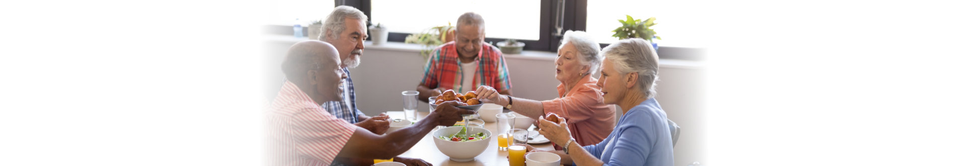 group of elderly people eating healthy foods